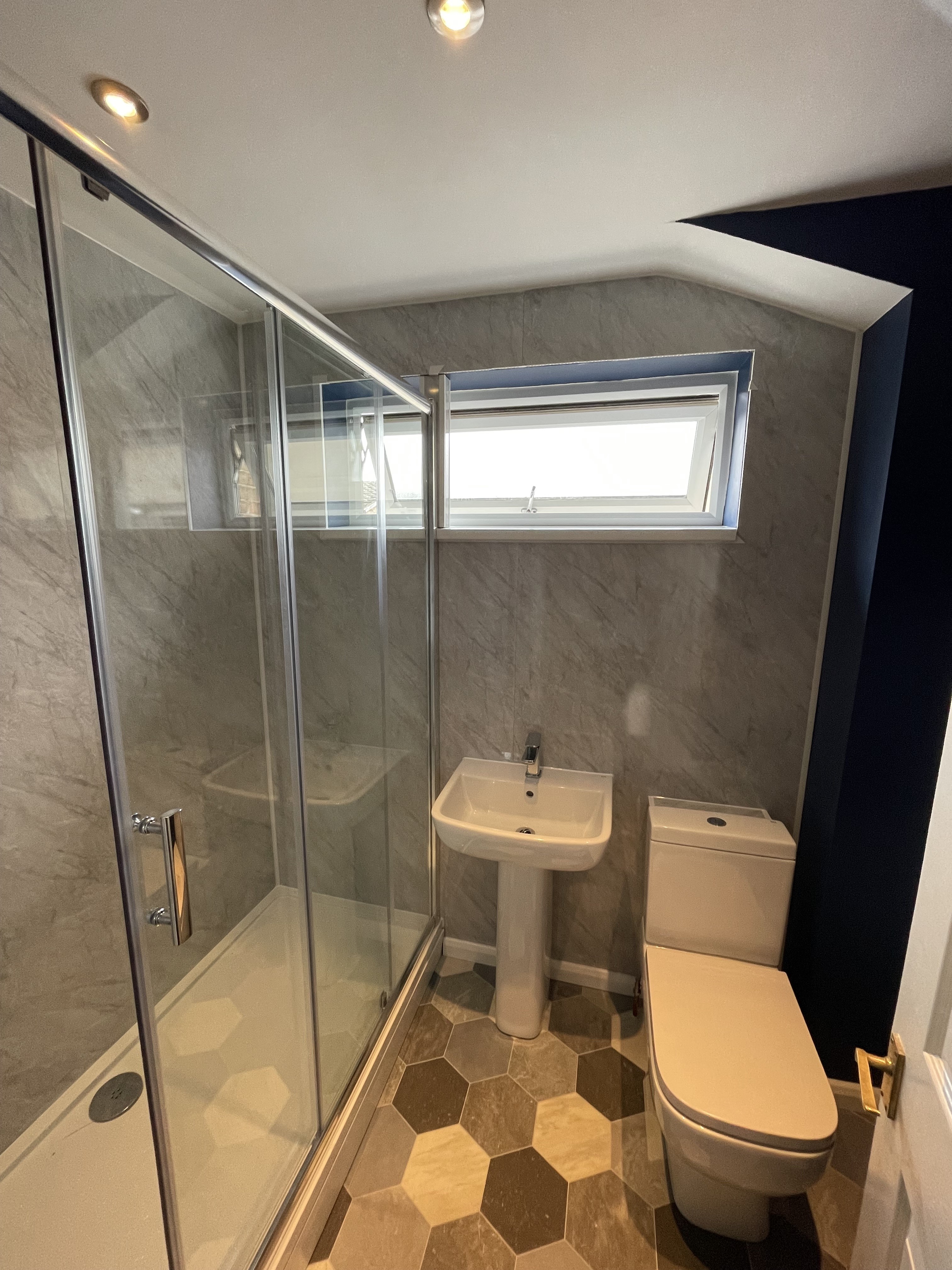 Bathroom with vinyl floor and heated towel rail