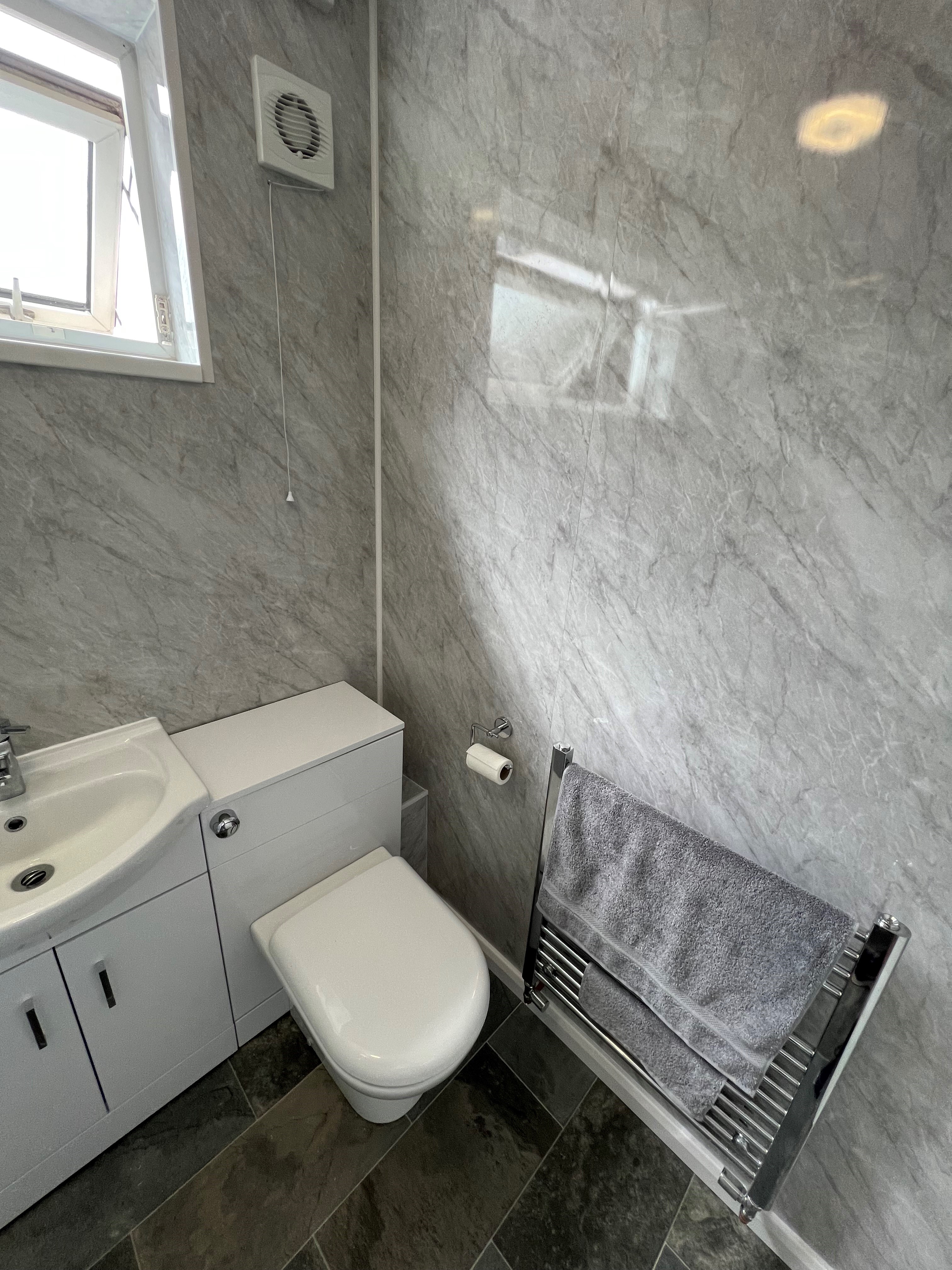 Bathroom with grey marble pvc panels